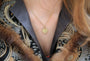 Gold Shasta Daisy Necklace on white female model in brocade jacket | Rebecca Myers Collection