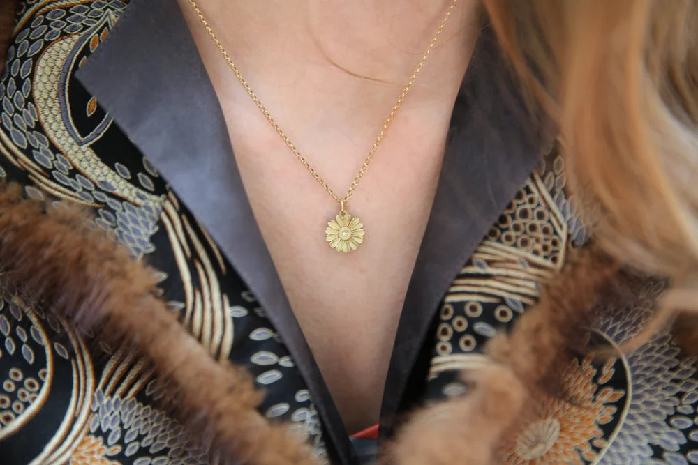 Gold Shasta Daisy Necklace on white female model in brocade jacket | Rebecca Myers Collection