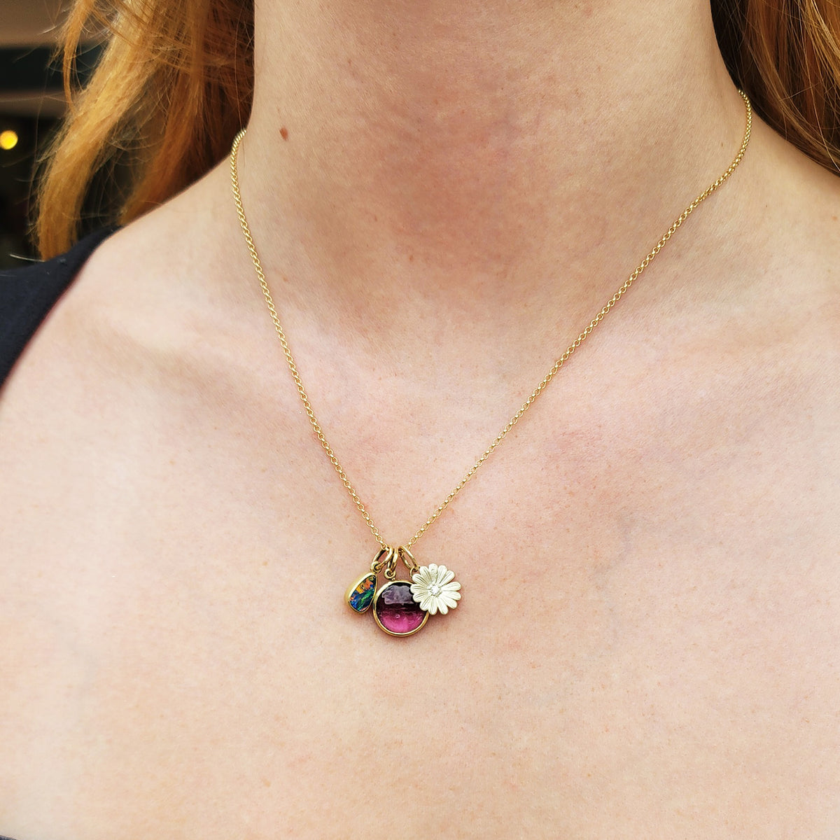 Round Pink Tourmaline Charm on Gold Chain + Gold & Diamond Shasta Daisy and Teardrop Boulder Opal Charms on white female model | Rebecca Myers Collection