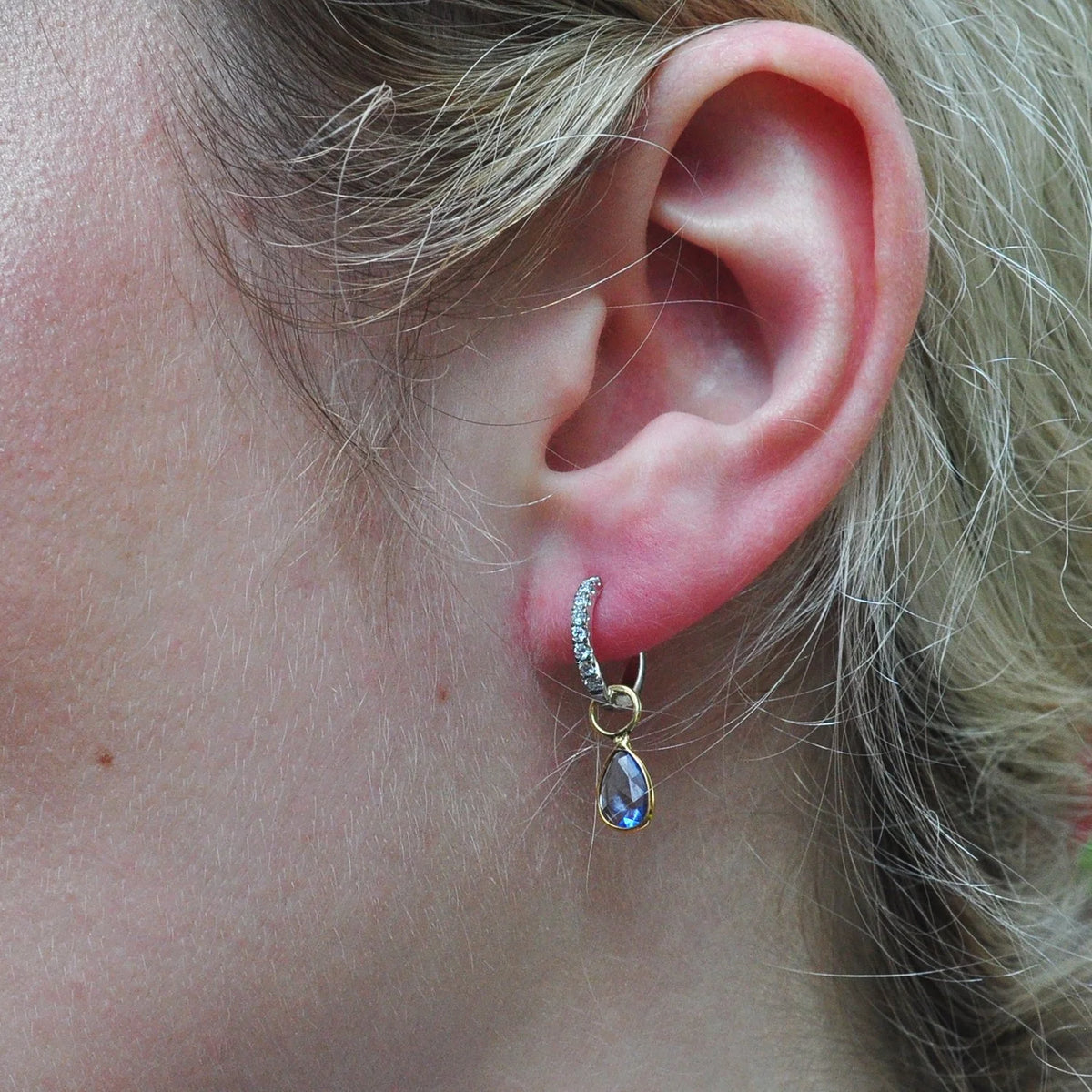 Gold Huggie Hoop Earrings with Diamonds & Blue Sapphire Charms on white female model | Rebecca Myers Collection