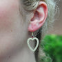 Large Gold Frame Heart Earrings with Ruby Tops on white female model | Rebecca Myers Collection