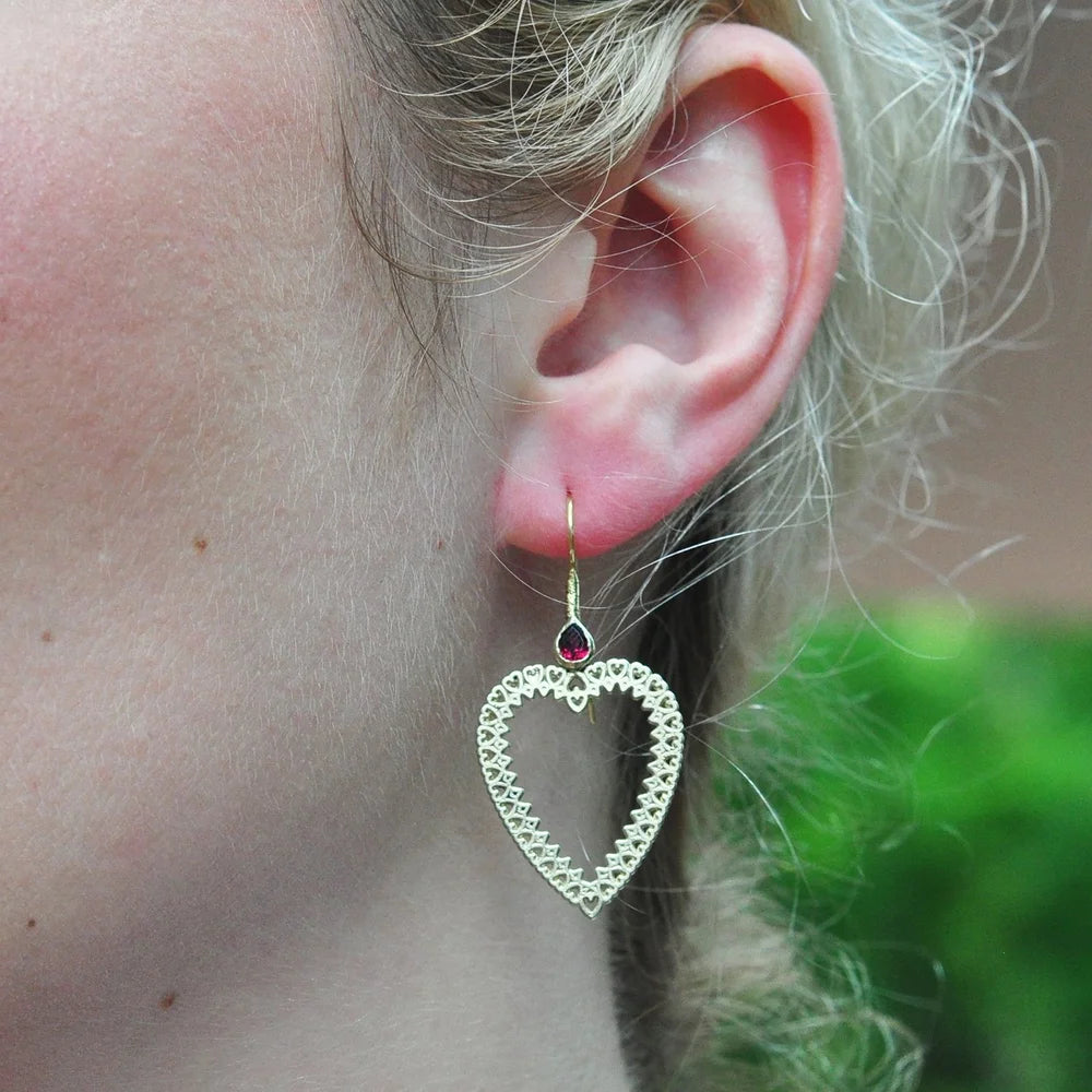 Large Gold Frame Heart Earrings with Ruby Tops on white female model | Rebecca Myers Collection