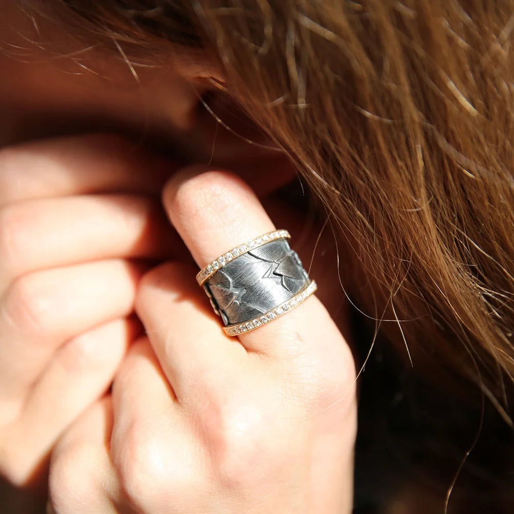 Oxidized Silver Feather Ring with White Gold Eternity Band Edges on white female with red hair | Rebecca Myers Collection