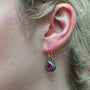 Pear Shaped Ruby Halo Earrings on white female model | Rebecca Myers Collections