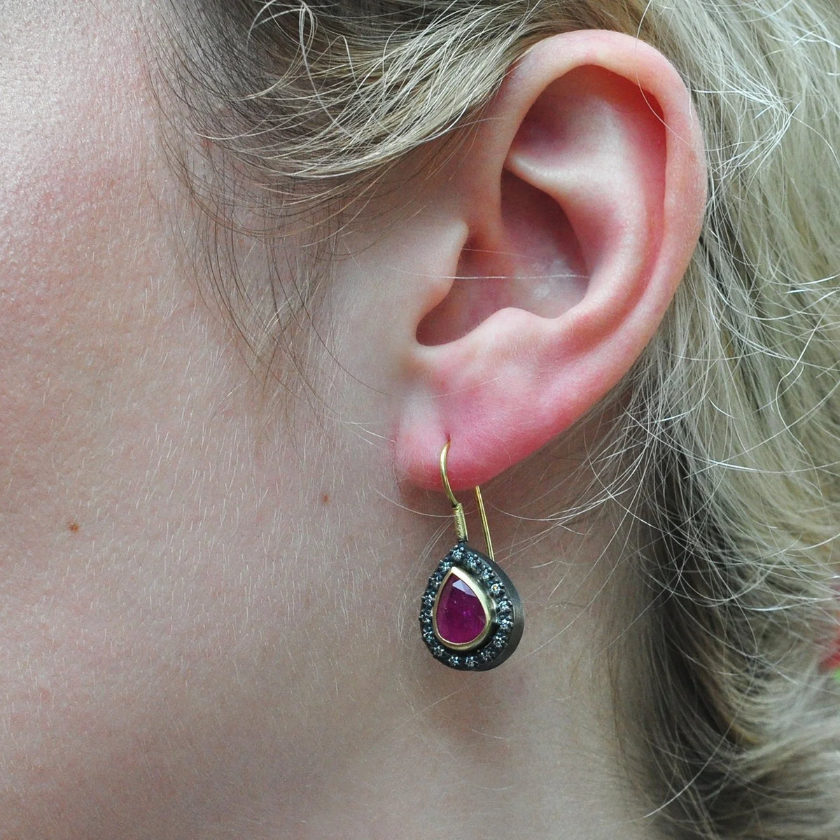 Pear Shaped Ruby Halo Earrings on white female model | Rebecca Myers Collections