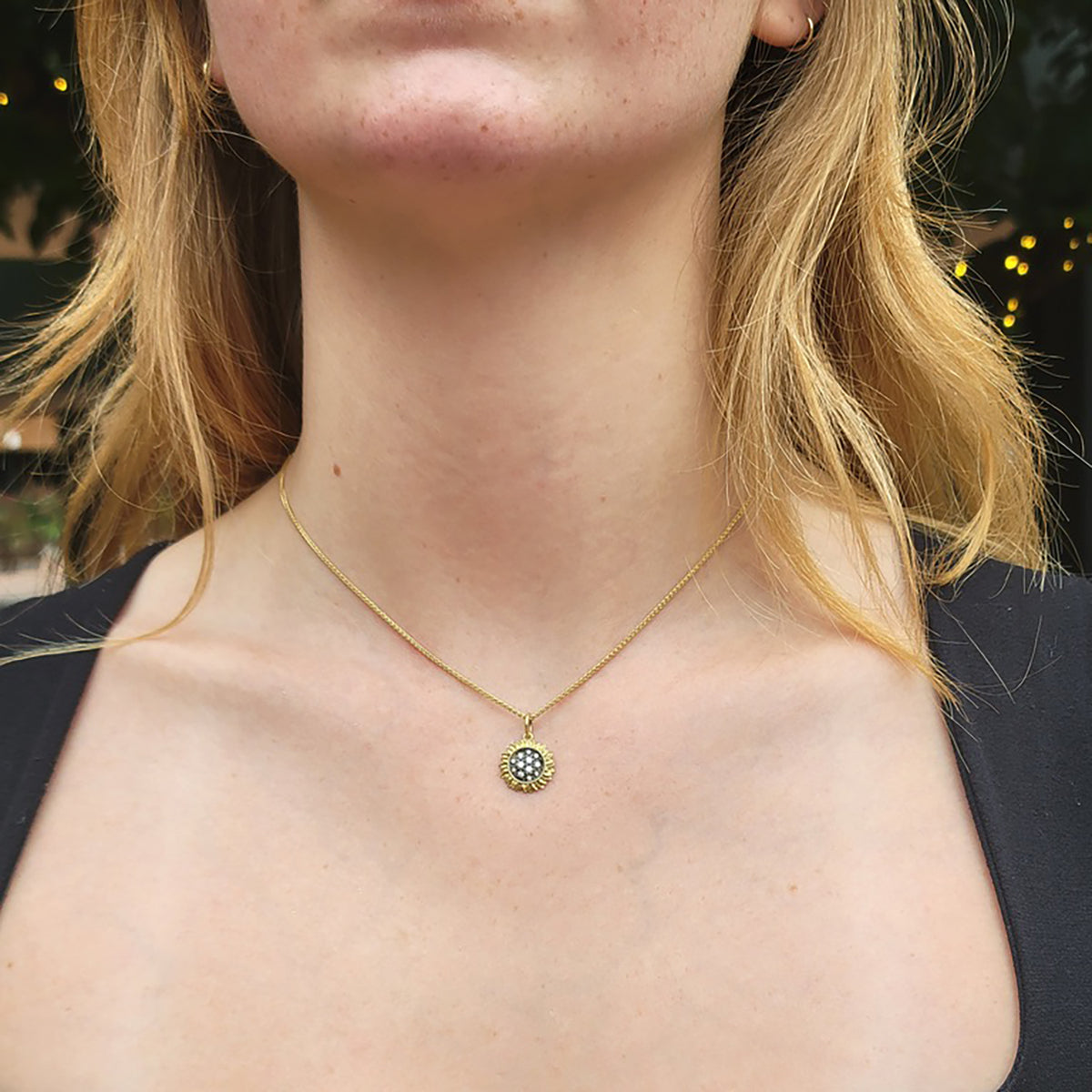 Small Pave Diamond Sunflower Charm on white female in black top | Rebecca Myers Collection