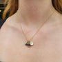 Necklace with Small Shasta Daisy, Teardrop Boulder Opal, Large Round Pink Tourmaline Charms on white female model | Rebecca Myers Collection