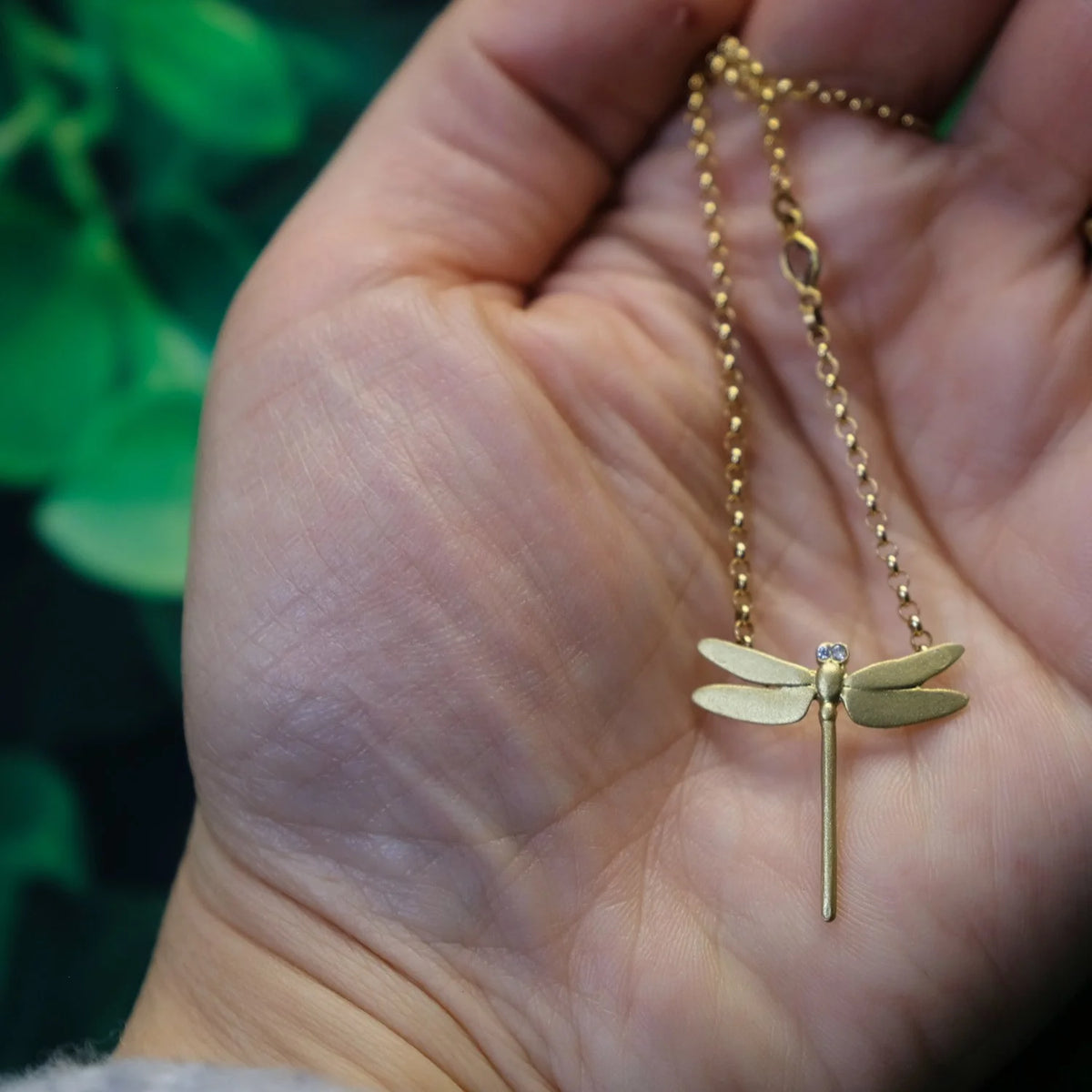 Gold Dragonfly Charm on Gold Rolo Chain in the palm of white female |Rebecca Myers Collection